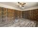 Room with unique bamboo walls, a ceiling fan, and gray wood-look floors at 352 18Th Ne Ave, Hickory, NC 28601