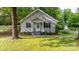 Charming gray home with a gabled roof, dark shutters, and a well-manicured lawn at 352 18Th Ne Ave, Hickory, NC 28601