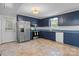 Traditional kitchen with blue cabinets, stainless steel appliances, and tile floors at 352 18Th Ne Ave, Hickory, NC 28601