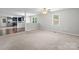 Open-concept living room featuring new carpet and neutral walls, with sightlines to the kitchen at 352 18Th Ne Ave, Hickory, NC 28601