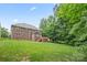 View of the home's backyard that has a green lawn and wooded tree line at 405 Deer Brush Ln, Waxhaw, NC 28173