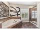 Modern bathroom featuring a soaking tub and separate glass enclosed shower with tile surround at 405 Deer Brush Ln, Waxhaw, NC 28173