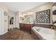 Large bathroom with double vanity, soaking tub, and large tile floor at 405 Deer Brush Ln, Waxhaw, NC 28173