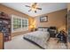 Comfortable bedroom featuring a neutral color scheme, ample natural light, and ceiling fan at 405 Deer Brush Ln, Waxhaw, NC 28173