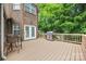 View of the deck that includes a grill, seating, and is attached to the red brick house at 405 Deer Brush Ln, Waxhaw, NC 28173