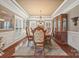Formal dining room featuring hardwood floors, wainscoting, and a decorative chandelier at 405 Deer Brush Ln, Waxhaw, NC 28173