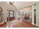 Elegant entryway with hardwood floors, chandelier, and a dining area beyond at 405 Deer Brush Ln, Waxhaw, NC 28173