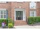 Close up of the brick entryway, showing the front door, stairs, and trimmed shrubs at 405 Deer Brush Ln, Waxhaw, NC 28173