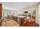 Open-concept kitchen with a large island, dining area, and view of the living room at 405 Deer Brush Ln, Waxhaw, NC 28173