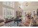 Elegant living room with high ceilings, bright windows, and zebra print rug at 405 Deer Brush Ln, Waxhaw, NC 28173