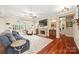 Bright living room boasting a stone fireplace, hardwood floors, and ample seating at 405 Deer Brush Ln, Waxhaw, NC 28173