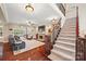 Inviting living room with hardwood floors, fireplace, and staircase at 405 Deer Brush Ln, Waxhaw, NC 28173