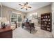 This home office features a dark wood desk, a decorative rug and lots of natural light at 405 Deer Brush Ln, Waxhaw, NC 28173