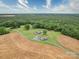 Stunning aerial view of property featuring a pond, two homes, multiple outbuildings and surrounding farmland and woods at 4115 Jenkins Rd, Marshville, NC 28103