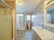 Bathroom features a tiled shower and tub combination and handrails for accessibility at 4115 Jenkins Rd, Marshville, NC 28103