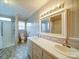 Bright bathroom featuring double sinks, a large mirror, and a tiled shower/tub combo at 4115 Jenkins Rd, Marshville, NC 28103