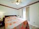 Comfortable bedroom with a decorative quilt, a ceiling fan, and a bright window at 4115 Jenkins Rd, Marshville, NC 28103