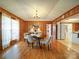 Charming dining room featuring wood paneling, hardwood floors and a chandelier at 4115 Jenkins Rd, Marshville, NC 28103
