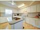 Spacious kitchen featuring white cabinets, an island with sink, and great natural light at 4115 Jenkins Rd, Marshville, NC 28103