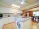 Bright kitchen featuring white cabinets, a center island, and an open view to the dining area at 4115 Jenkins Rd, Marshville, NC 28103