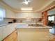 Well-lit kitchen featuring white cabinetry, center island, and modern appliances and wood-look flooring at 4115 Jenkins Rd, Marshville, NC 28103