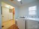 Bright laundry room featuring a washer, dryer, and storage, conveniently located near the pantry at 4115 Jenkins Rd, Marshville, NC 28103