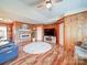 Spacious living room featuring a decorative fireplace, wood paneling, and ample seating at 4115 Jenkins Rd, Marshville, NC 28103