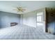 Spacious living room with neutral carpet, ceiling fan, and open doorway to the sunlit room for a bright and airy feel at 4115 Jenkins Rd, Marshville, NC 28103