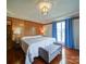 Main bedroom with wood-paneled accent wall, hardwood floors, and bright window at 4115 Jenkins Rd, Marshville, NC 28103