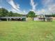 Expansive property featuring a house, outbuilding, and covered storage area, offering versatile space at 4115 Jenkins Rd, Marshville, NC 28103