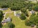 Expansive aerial view of a property featuring a home and surrounding green spaces, showcasing its peaceful, wooded setting at 4285 Palmer Lloyd Rd, Lancaster, SC 29720