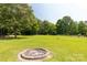 Grassy backyard featuring a brick fire pit and plenty of open space, great for gatherings or relaxing at 4285 Palmer Lloyd Rd, Lancaster, SC 29720
