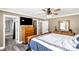 This bedroom features a ceiling fan, TV, and an ensuite bathroom with decorative mirror at 4285 Palmer Lloyd Rd, Lancaster, SC 29720