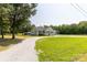 Charming single-story home with a well-manicured lawn and a gravel driveway, creating a welcoming curb appeal at 4285 Palmer Lloyd Rd, Lancaster, SC 29720