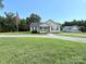 Cozy one-story home featuring a manicured lawn, an American flag, and a gravel driveway at 4285 Palmer Lloyd Rd, Lancaster, SC 29720