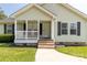 Inviting front porch with brick steps and white railing, enhancing curb appeal and providing a welcoming entrance at 4285 Palmer Lloyd Rd, Lancaster, SC 29720