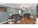 Cozy living room with plush sofas, wood flooring, and a ceiling fan, perfect for relaxation and entertainment at 4285 Palmer Lloyd Rd, Lancaster, SC 29720