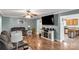 Comfortable living room featuring a large TV, stylish entertainment center, and a glimpse into the adjacent kitchen at 4285 Palmer Lloyd Rd, Lancaster, SC 29720