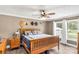 Comfortable main bedroom with a wooden bed frame, soft bedding, and ample natural light from a nearby window at 4285 Palmer Lloyd Rd, Lancaster, SC 29720