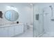 This bathroom features a modern vanity, a large round mirror, and a glass enclosed shower at 4323 Rosecliff Dr, Charlotte, NC 28277