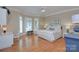 This bedroom features hardwood floors, a large bed, bay windows with plantation shutters, and custom paint at 4323 Rosecliff Dr, Charlotte, NC 28277