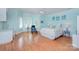 The main bedroom features wood floors, pastel blue paint, plantation shutters, and neutral bedding at 4323 Rosecliff Dr, Charlotte, NC 28277