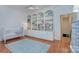 This neutral Bedroom features a built-in bookcase, light blue rug, and a white crib at 4323 Rosecliff Dr, Charlotte, NC 28277