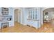 Elegant dining area with built-in cabinets, hardwood floors, and arched doorways, creating a warm and inviting space at 4323 Rosecliff Dr, Charlotte, NC 28277