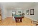 This large game room features a vintage billiards table, hardwood floors, and neutral paint at 4323 Rosecliff Dr, Charlotte, NC 28277
