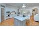 Beautiful, bright kitchen with white cabinets, a large island, stainless steel appliances, and hardwood floors at 4323 Rosecliff Dr, Charlotte, NC 28277