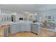 Open concept kitchen featuring stainless steel appliances, island with sink, and hardwood flooring at 4323 Rosecliff Dr, Charlotte, NC 28277
