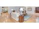 Cozy living room featuring hardwood floors, plush seating, and a view into the kitchen and dining areas at 4323 Rosecliff Dr, Charlotte, NC 28277