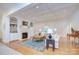 Elegant living room featuring a coffered ceiling, fireplace, built-in shelving, and hardwood floors at 4323 Rosecliff Dr, Charlotte, NC 28277