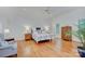 Spacious main bedroom with hardwood floors, ceiling fan, and abundant natural light at 4323 Rosecliff Dr, Charlotte, NC 28277